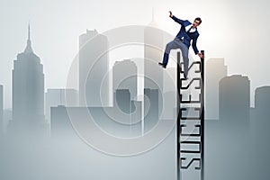 The businessman slipping from the top of ladder