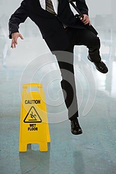 Businessman Slipping on Wet Floor