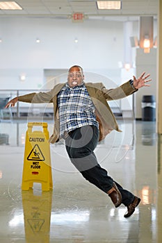 Businessman Slipping on Wet Floor