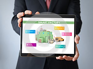 businessman with smart factory on a tablet
