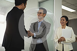 Businessman in smart office suit shaking their hands with partners and secretary after successfully negotiated business together