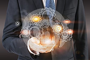 Businessman with smartphone, gears and graph