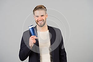 Businessman smile with shampoo or gel bottle in hand, spa. Man with stylish hair, haircut, salon. Mens hygiene, grooming, beauty.