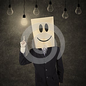 Businessman with smiley emoticon having idea