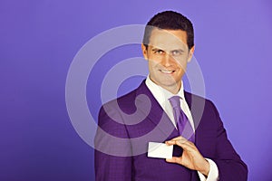 Businessman smiling with business or bank card