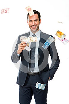 Businessman smiling in falling money