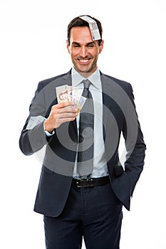 Businessman smiling in falling money