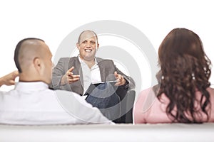 Businessman Smiling In Front Of Two Colleague