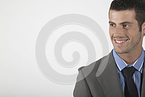 Businessman Smiling On Gray Background