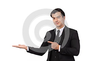 Businessman smiling, holding open palm with empty copy space. Business man showing hand sign to side concept of advertisement
