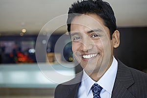 Businessman Smiling In Hotel Lobby