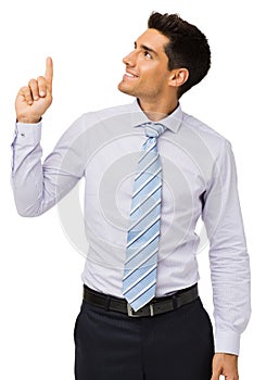 Businessman Smiling While Pointing Upwards