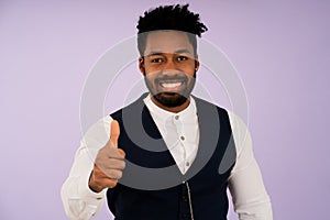 Businessman smiling while showing thumb up to camera.