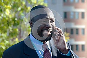 Businessman Smiling & Talking on Cell Phone