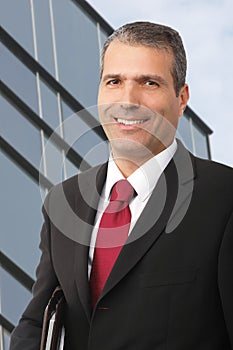 Businessman smilling with noteboo