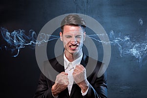 Businessman smoking with anger