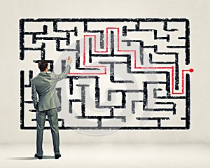 Businessman solving labyrinth problem