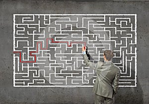 Businessman solving labyrinth problem