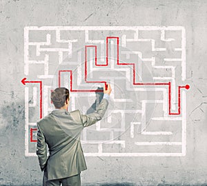 Businessman solving labyrinth problem