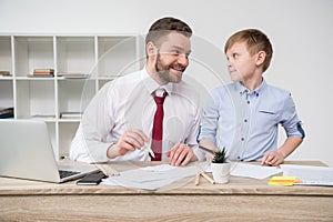 Businessman with son drawing at table