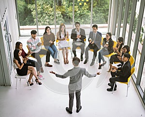 Businessman speaker giving a talk at business meeting. Audience in conference room.