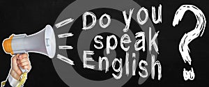 A businessman speaks into a loudspeaker, next to the text - Do you speak English. No face visible