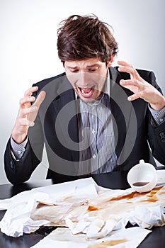 Businessman spilled coffee on the very important documents