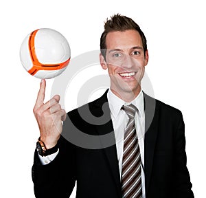 Businessman spinning soccer ball