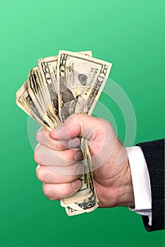 Businessman squeezing cash photo