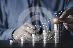 Businessman stack increasing coins money with bar graph and stock market chart for business investment profit and deposit dividend