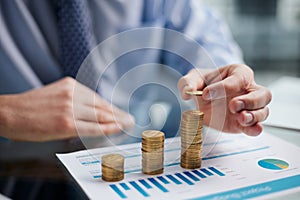 Businessman stacking coins on table, business growth concept. Hand puts coin to stack.