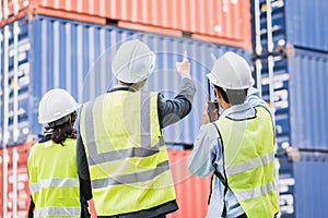 Businessman with staff in logistic, export, import industry checking shipping cargo container