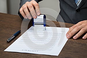 Businessman stamping document