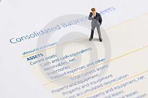 Businessman stand on the balance sheet