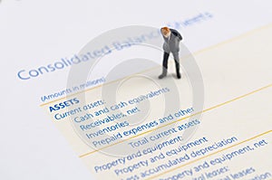 Businessman stand on the balance sheet