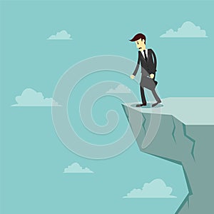 Businessman stand on the edge of cliff and feeling stressed