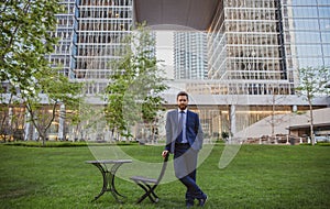 Businessman stand up and night city background. Boss in open business center. Successful business man outside.