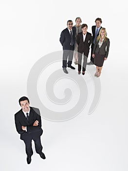 Businessman Standing Apart From Group