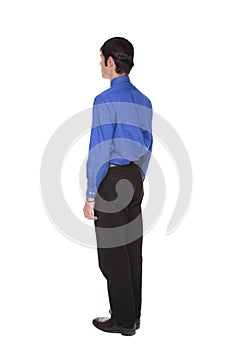 Businessman standing with arms at sides rear view