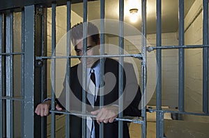 Businessman Standing Behind Bars