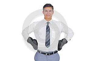Businessman standing with black boxing gloves