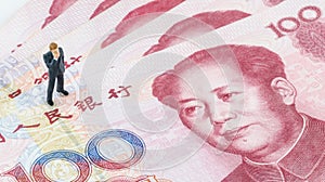 Businessman standing on the Chinese banknote