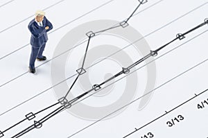 Businessman standing on the compare graph