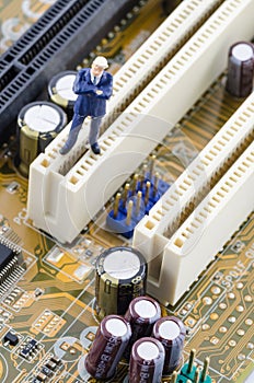 Businessman standing on the Computer motherboard