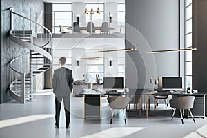 Businessman standing in contemporary coworking office interior with stairs