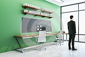 Businessman standing in contemporary workplace