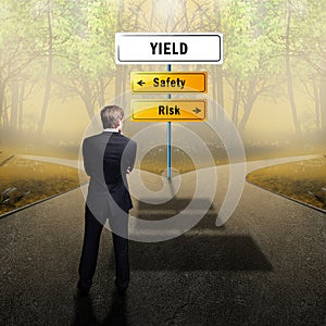 Businessman standing on a crossroad having the options Safety and Risk