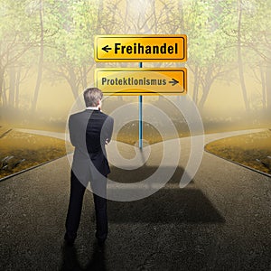 Businessman standing at a crossroad having to decide between `free trade ` and `protectionism `
