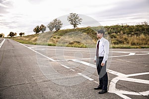 Businessman standing at crossroads. Concept of choice