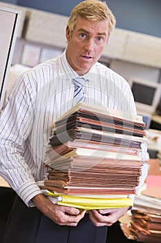 Businessman standing in cubicle